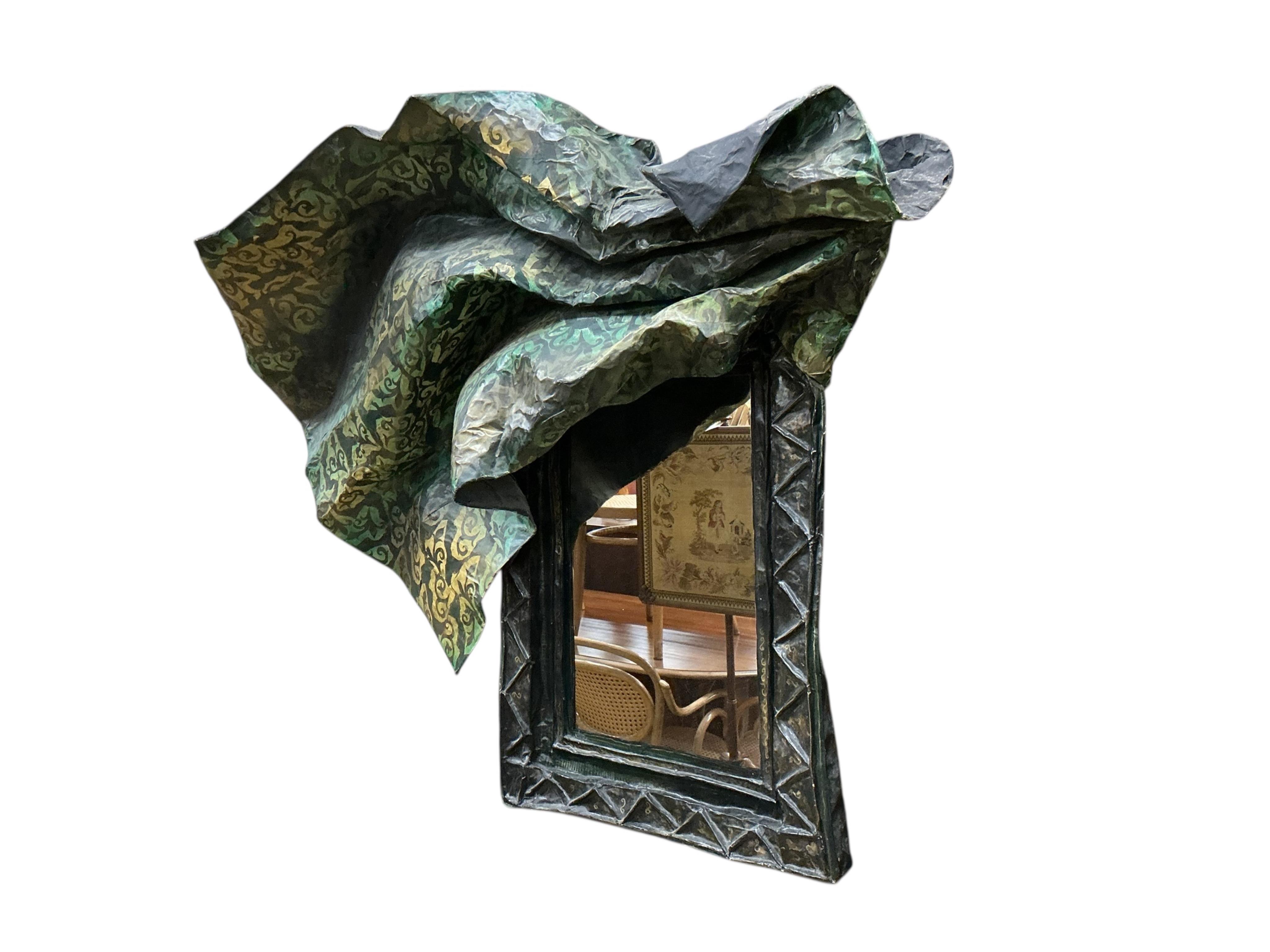 A 20th century papier mache framed mirror modelled as a piece of brocade fabric draped over the rectangular mirror frame, width 120cm, height 102cm